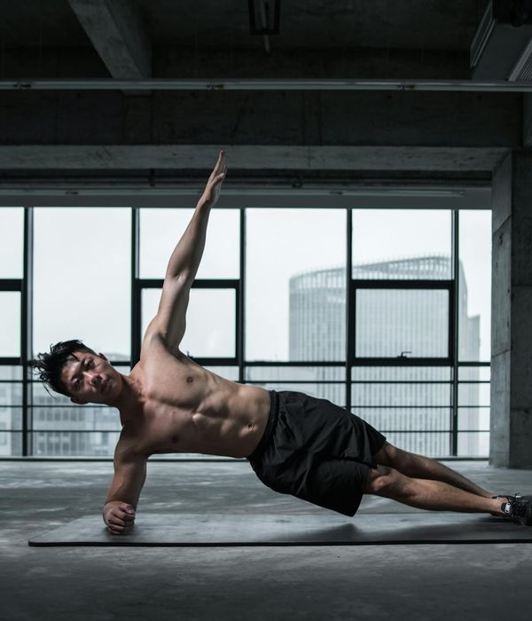Strong man practicing bodyweight exercises in a modern training hall